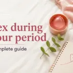 Text 'Sexo con la regla Guía completa' next to a pink menstrual cup, a green plant, and a notebook with a heart.