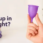 A hand holds a purple menstrual cup next to text "¿Copa bien colocada?" and a small heart.
